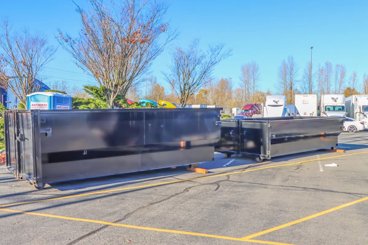 Professional dumpster rental service with roll-off container on residential driveway in Parkwood